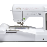 Picture of Baby Lock Bloom sewing machine with display and control buttons. The machine is extended with an embroidery loop inside.